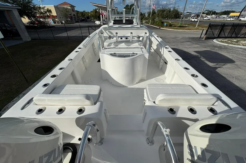 Slide: The Image of 2021 Twin Vee 260 CC GF boat interior with seating and fishing rod holders. - 30