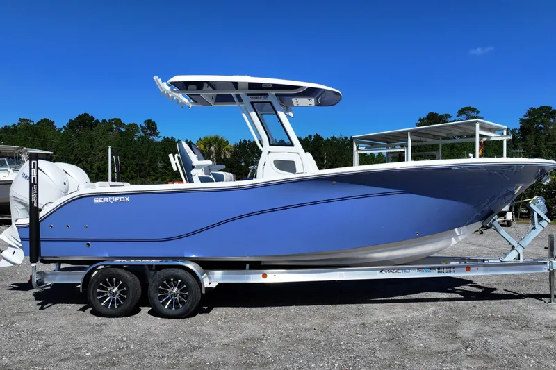 The Image of 2026 Sea Fox 268 Commander boat on trailer under clear blue sky. - 0