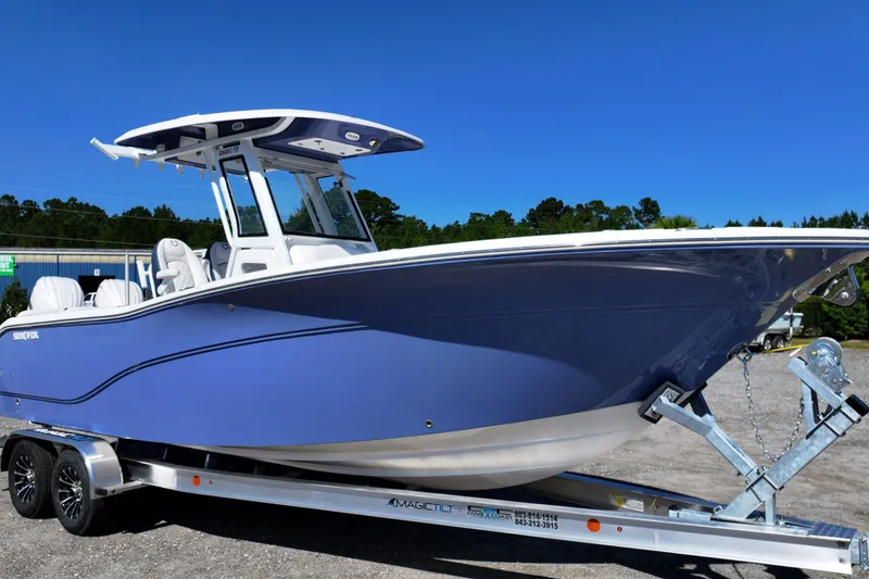 Slide: The Image of 2026 Sea Fox 268 Commander boat on trailer, blue hull, clear sky background. - 1