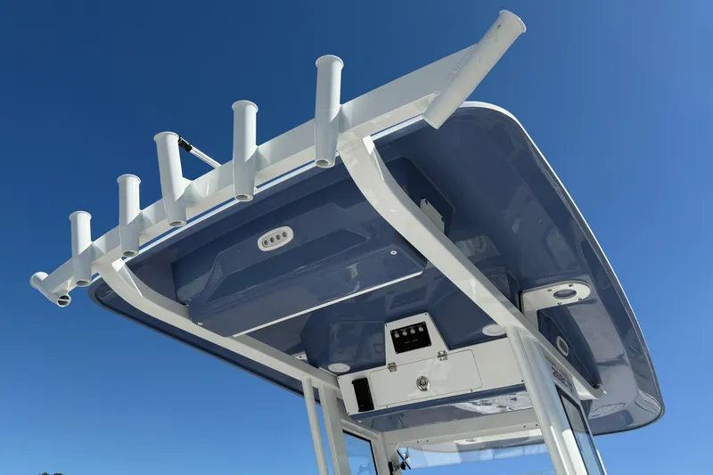 Slide: The Image of 2026 Sea Fox 268 Commander boat top view with rod holders against clear blue sky. - 22