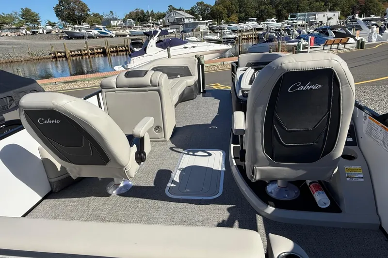 Slide: The Image of 2026 Barletta C24UC boat interior with Cabrio seats at a marina. - 12