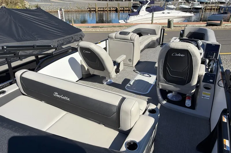 Slide: The Image of 2026 Barletta C24UC boat interior with luxurious seating and modern design. - 13