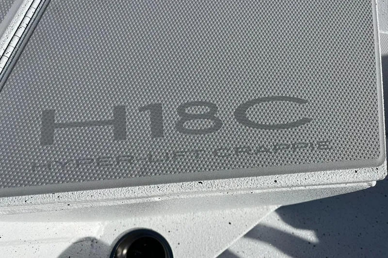 Slide: The Image of 2026 Express H18C Crappie boat deck with textured surface and branding. - 10