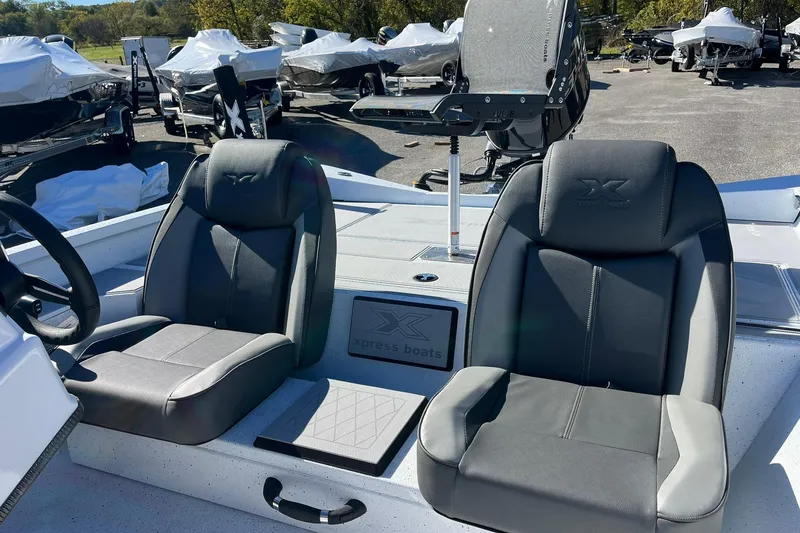 Slide: The Image of 2026 Express H18C Crappie boat interior with Yamaha Vmax 115 SHO, featuring two black seats. - 14