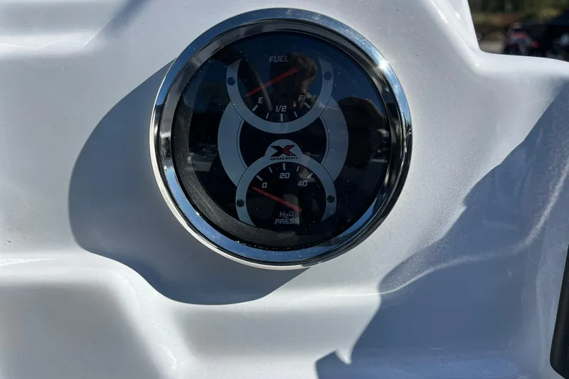 Slide: The Image of Close-up of 2026 Express H18C Crappie boat gauge, displaying fuel and pressure levels. - 16