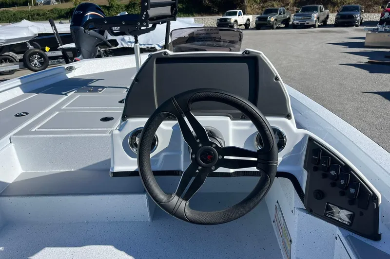 Slide: The Image of 2026 Express H18C Crappie boat dashboard with Yamaha Vmax 115 SHO engine in background. - 18