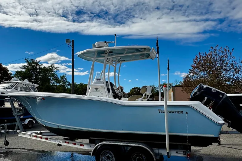 Slide: The Image of 2016 Tidewater 232 CC Adventure boat on trailer under blue sky. - 3