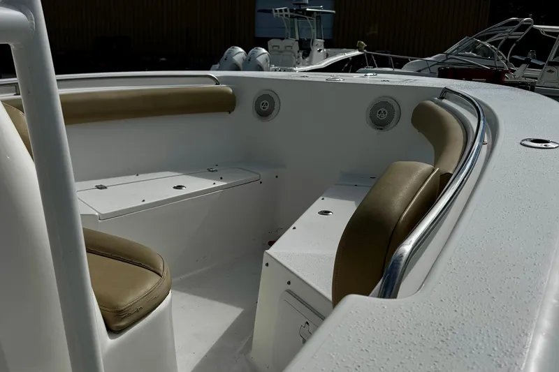 Slide: The Image of 2016 Tidewater 232 CC Adventure boat interior with cushioned seating and storage compartments. - 7