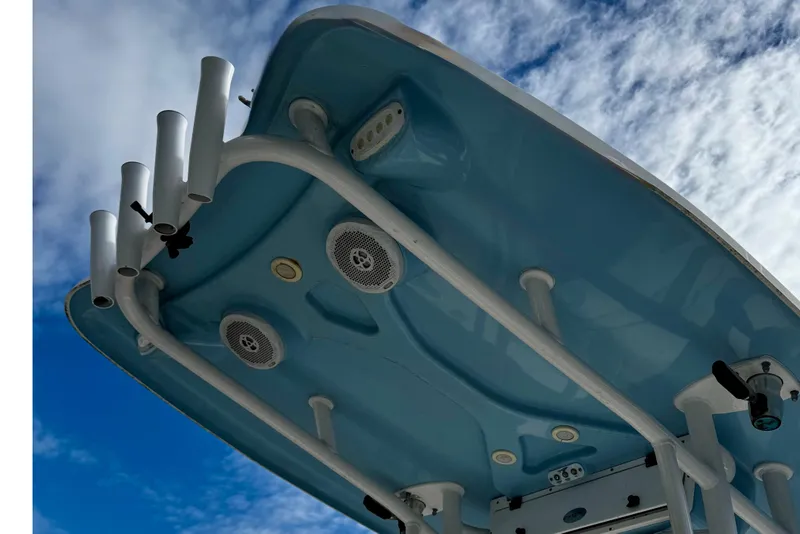 Slide: The Image of Tidewater 232 CC Adventure 2016 boat top view with rod holders and speakers against sky. - 8