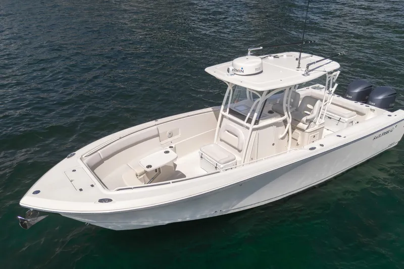 The Image of 2015 Sailfish 320 CC boat on water, featuring dual engines and spacious deck. - 0