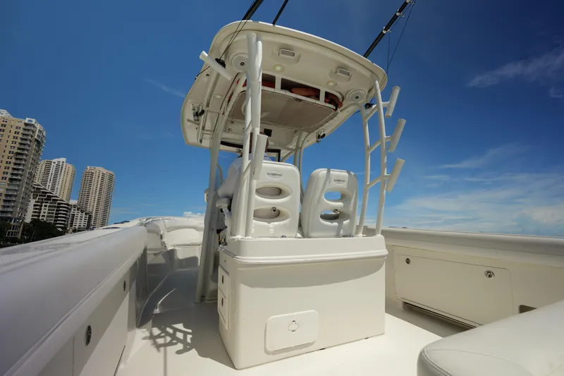 Slide: The Image of 2015 Sailfish 320 CC boat interior with seating, under clear blue sky. - 11