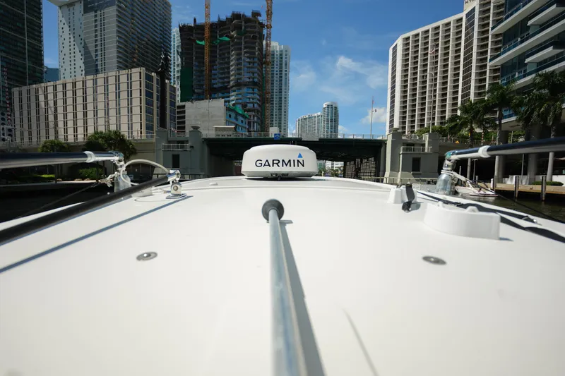 Slide: The Image of 2015 Sailfish 320 CC boat navigating urban waterway with Garmin equipment. - 12