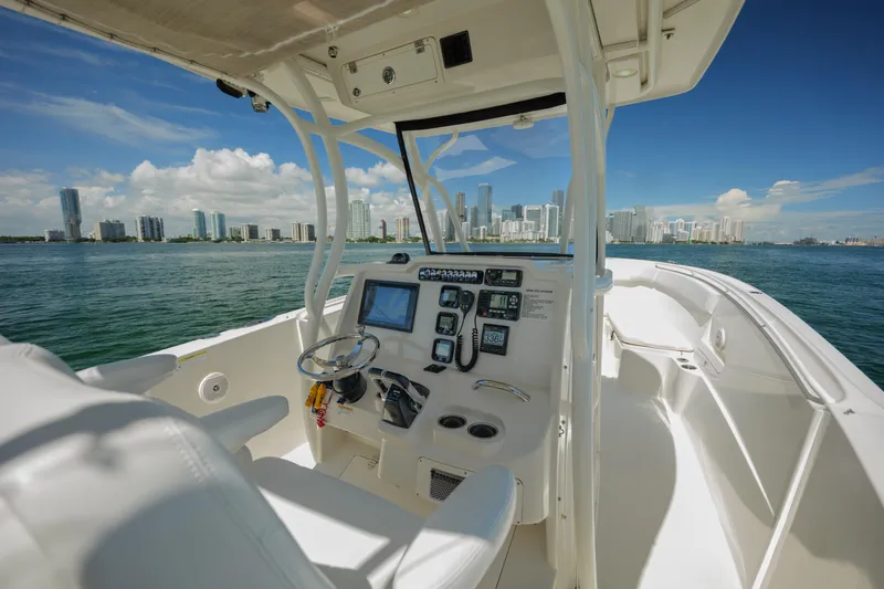 Slide: The Image of 2015 Sailfish 320 CC boat interior with city skyline view. - 15