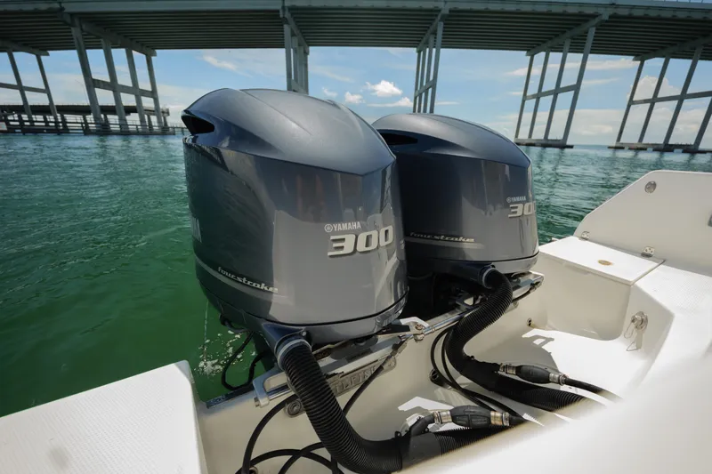 Slide: The Image of Twin Yamaha 300 outboard engines on a 2015 Sailfish 320 CC boat under a bridge. - 16