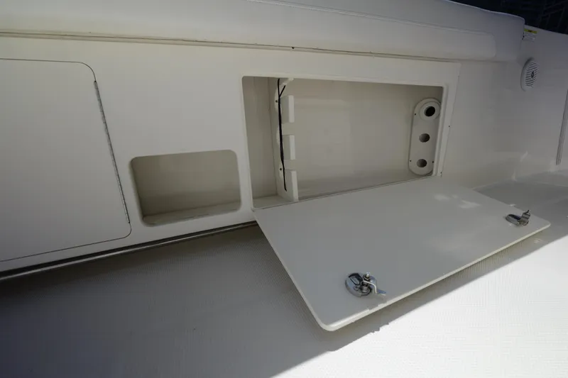 Slide: The Image of Open storage compartment on 2015 Sailfish 320 CC boat deck. - 18