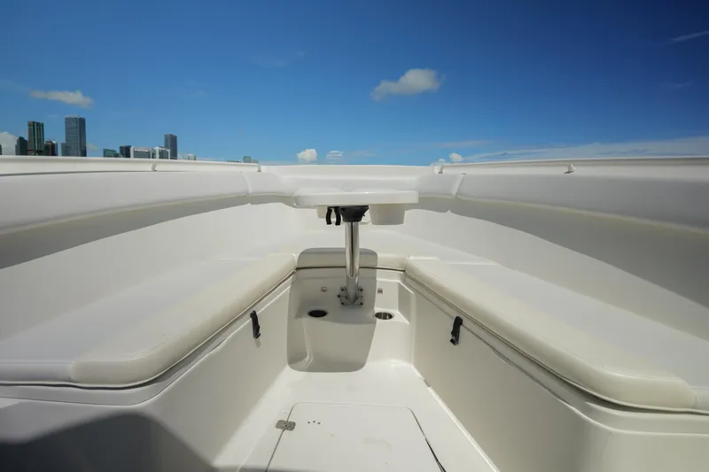 Slide: The Image of 2015 Sailfish 320 CC boat interior with seating, under clear blue sky. - 22