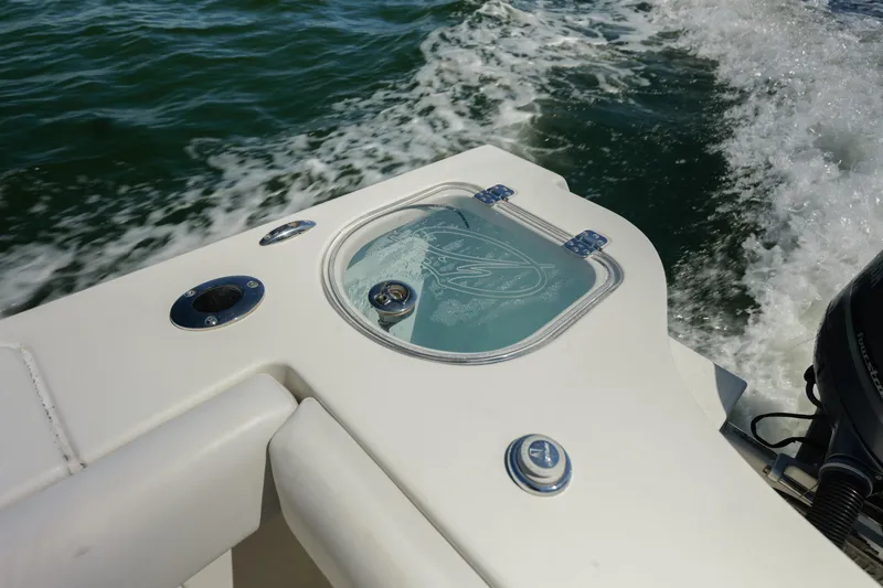 Slide: The Image of 2015 Sailfish 320 CC boat detail with water splashing in the background. - 24
