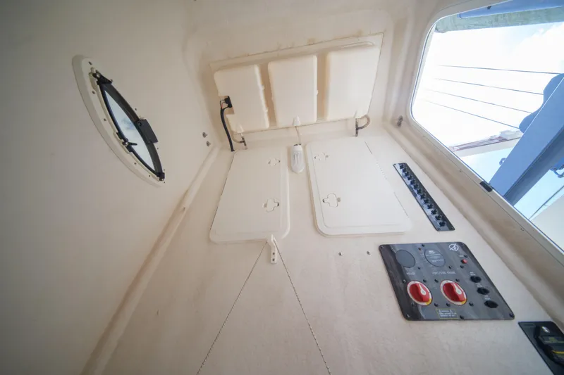 Slide: The Image of Interior view of 2015 Sailfish 320 CC boat cabin with control panels and porthole. - 26