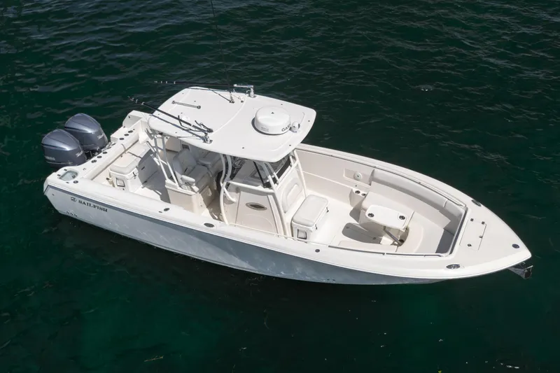 Slide: The Image of 2015 Sailfish 320 CC boat with dual engines on calm water. - 3