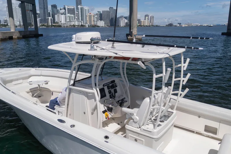 Slide: The Image of 2015 Sailfish 320 CC boat docked with city skyline in background. - 7