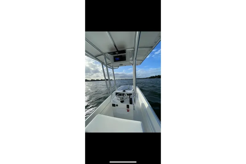 Slide: The Image of 1978 Boston Whaler 17 Montauk boat on open water under a clear sky. - 5