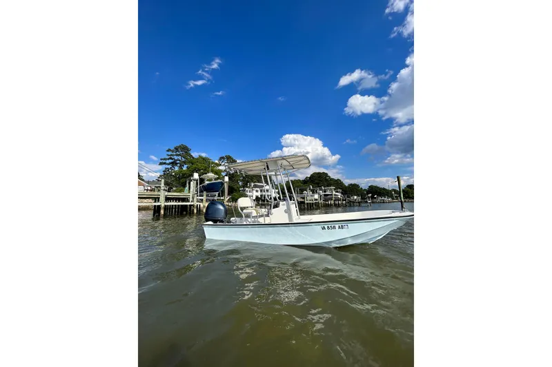 Slide: The Image of 1978 Boston Whaler 17 Montauk boat on water under clear blue sky. - 6