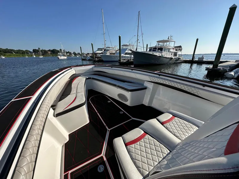 Slide: The Image of 2017 Statement 380 Open boat interior with luxurious seating at a marina. - 10