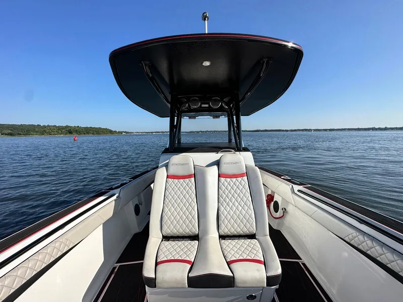 Slide: The Image of 2017 Statement 380 Open boat interior with dual seats on calm water. - 12