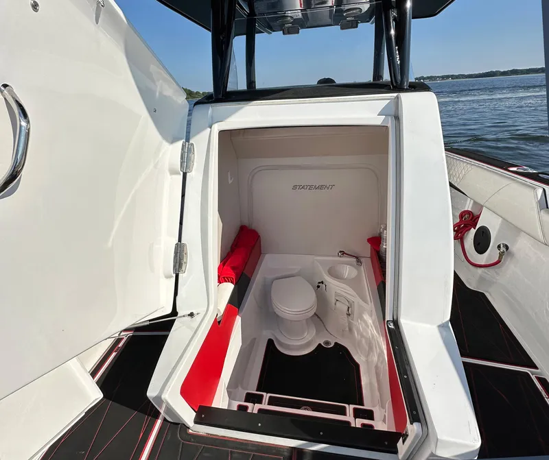 Slide: The Image of 2017 Statement 380 Open boat interior with compact bathroom and red accents. - 13