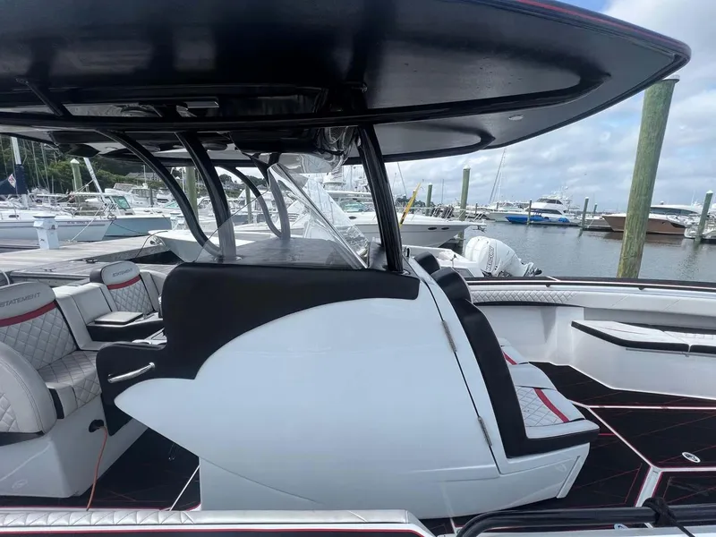 Slide: The Image of 2017 Statement 380 Open boat interior at marina, featuring sleek seating and modern design. - 14