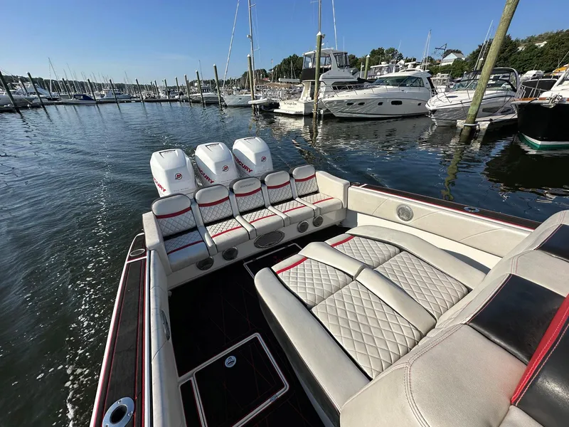 Slide: The Image of 2017 Statement 380 Open boat with triple engines docked in a marina. - 19