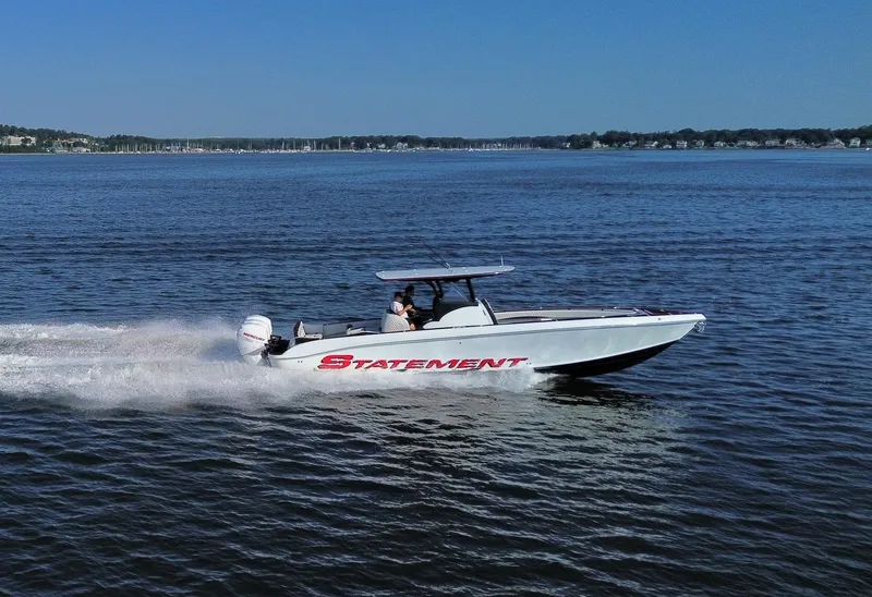 Slide: The Image of 2017 Statement 380 Open boat cruising on a calm lake under a clear blue sky. - 2