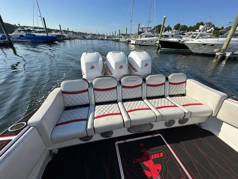 Slide: The Image of 2017 Statement 380 Open boat with luxurious seating and powerful engines at a marina. - 20
