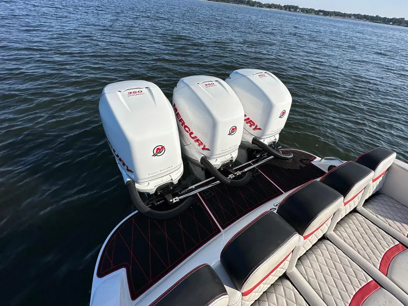 Slide: The Image of 2017 Statement 380 Open boat with triple Mercury outboard engines on water. - 21