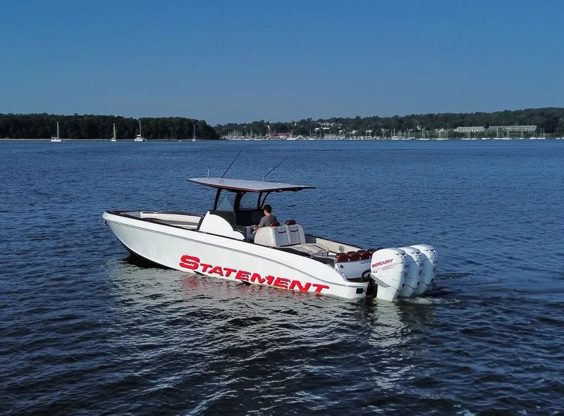 Slide: The Image of 2017 Statement 380 Open boat cruising on a calm lake with scenic background. - 22