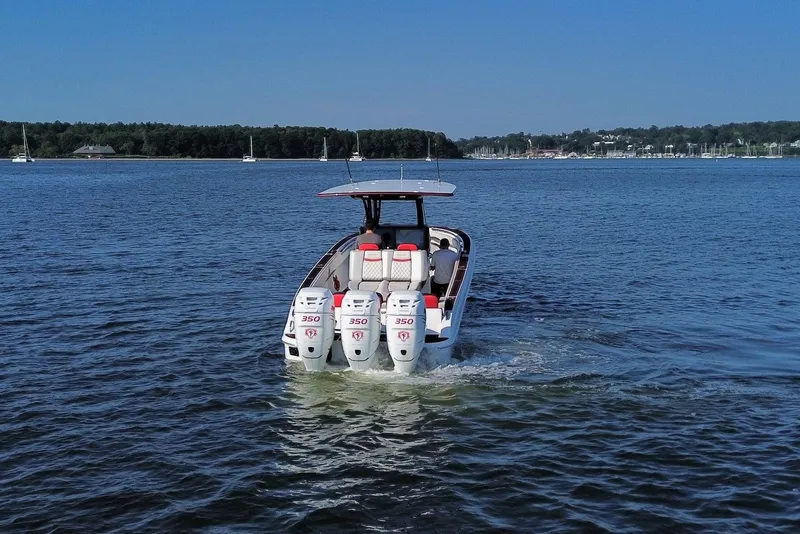 Slide: The Image of 2017 Statement 380 Open boat with triple engines cruising on a calm lake. - 23