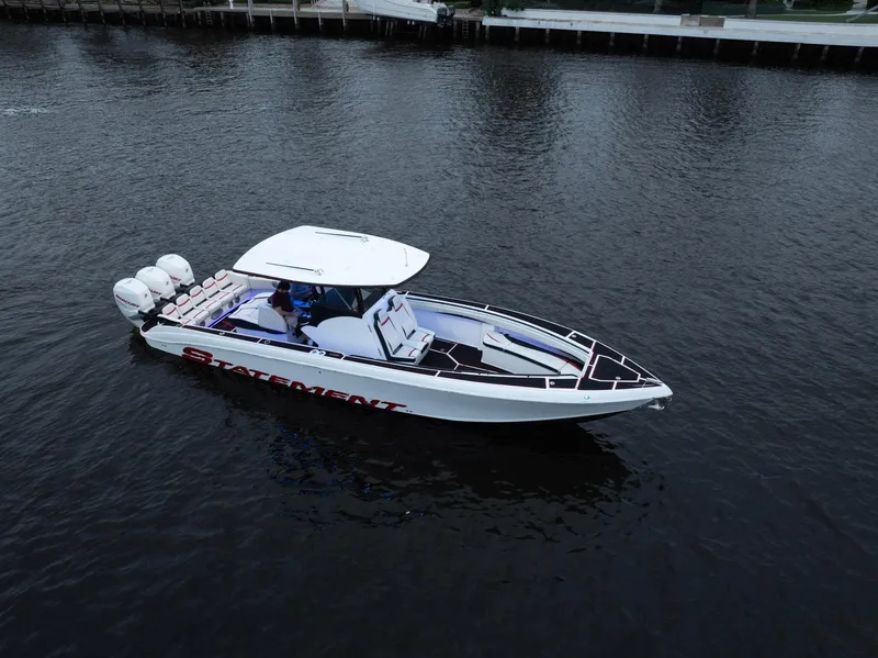Slide: The Image of 2017 Statement 380 Open boat on calm water, featuring sleek design and powerful engines. - 29