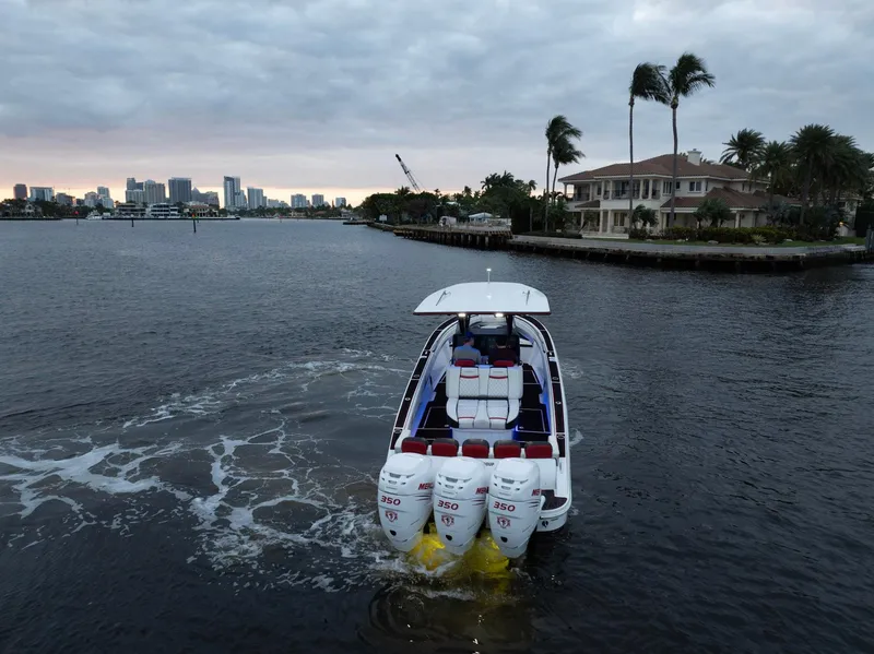 Slide: The Image of Statement 380 Open 2017 boat cruising near waterfront homes and city skyline. - 32