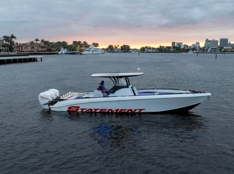 Slide: The Image of 2017 Statement 380 Open boat on water at sunset, city skyline in background. - 35