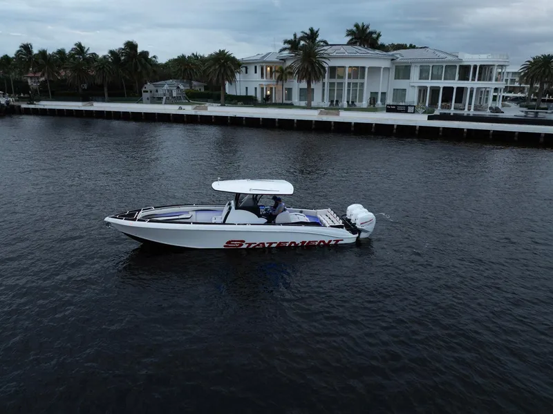 Slide: The Image of 2017 Statement 380 Open boat on water near luxury waterfront home. - 38