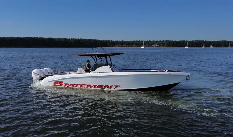 Slide: The Image of 2017 Statement 380 Open boat cruising on a calm lake under a clear blue sky. - 5