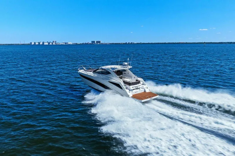 Slide: The Image of 2017 Galeon 385 HTS yacht cruising on open blue water. - 12