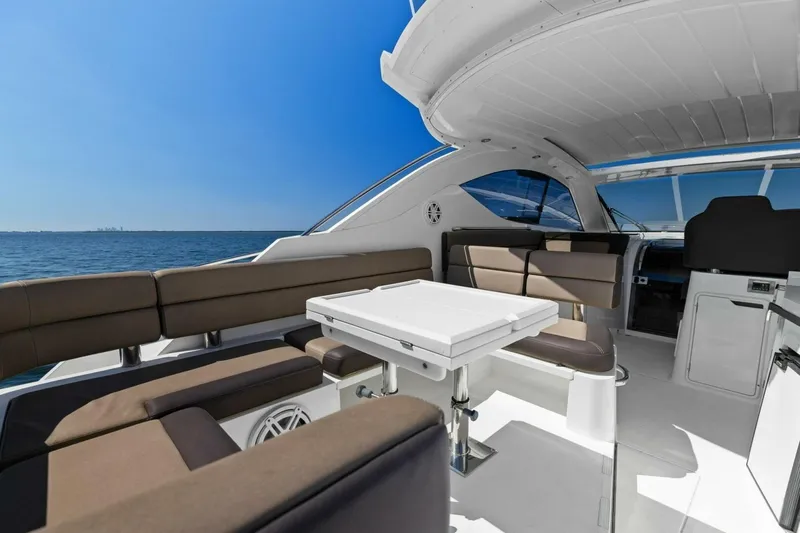 Slide: The Image of Luxurious 2017 Galeon 385 HTS yacht interior with seating and table, overlooking the ocean. - 22