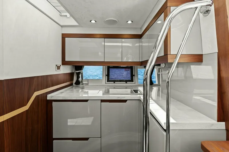 Slide: The Image of Modern kitchen interior on 2017 Galeon 385 HTS yacht, featuring sleek cabinetry and ocean view. - 31