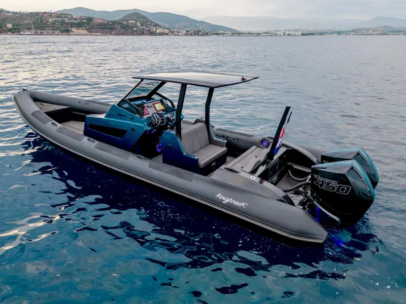 Slide: The Image of 2023 Roughneck 36 T Top boat on calm water, featuring sleek design and powerful engines. - 0