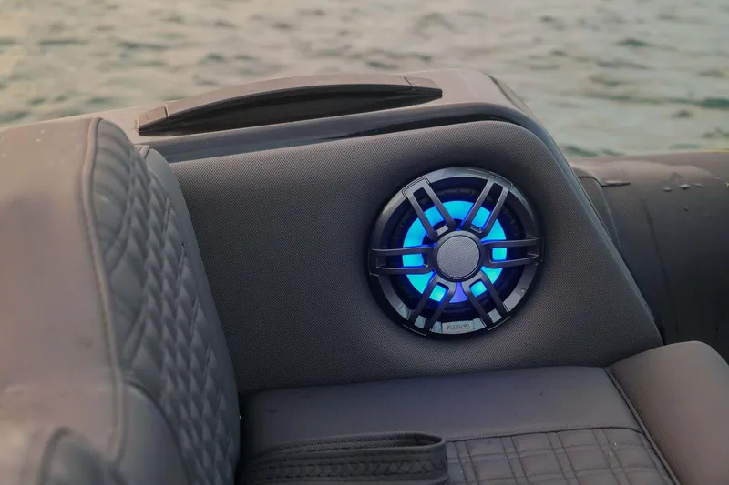 Slide: The Image of 2023 Roughneck 36 T Top boat with illuminated speaker, quilted seating, and ocean backdrop. - 19