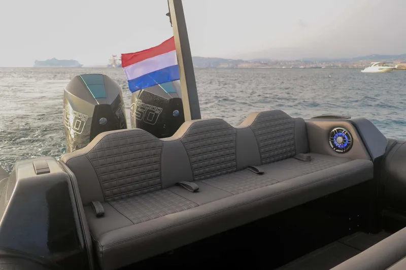 Slide: The Image of 2023 Roughneck 36 T Top boat with Dutch flag, twin engines, and rear seating on open water. - 34