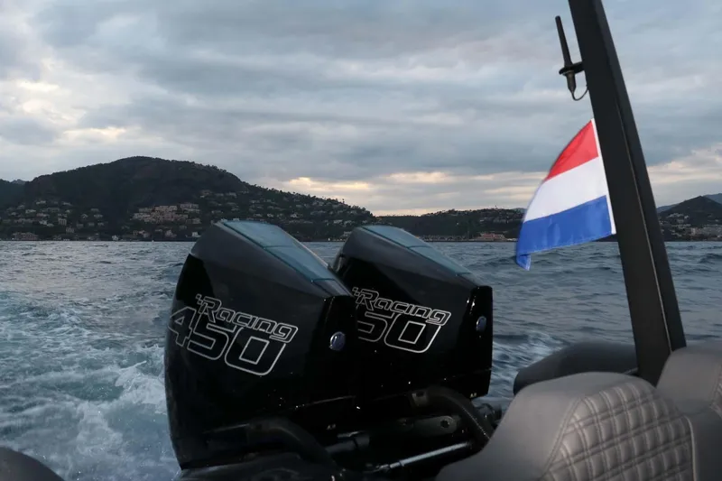 Slide: The Image of 2023 Roughneck 36 T Top boat with dual Racing 450 engines on a scenic waterway. - 36