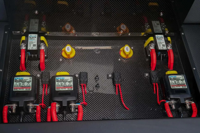 Slide: The Image of Electrical panel of 2023 Roughneck 36 T Top boat with red and yellow components. - 38