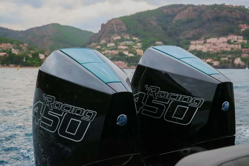 Slide: The Image of Twin Mercury Racing 450 engines on a 2023 Roughneck 36 T Top boat, scenic coastal backdrop. - 39